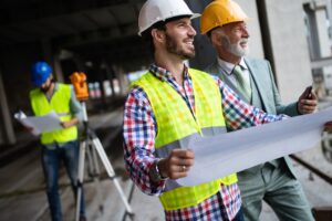 Engineer, foreman and worker discussing in building construction site