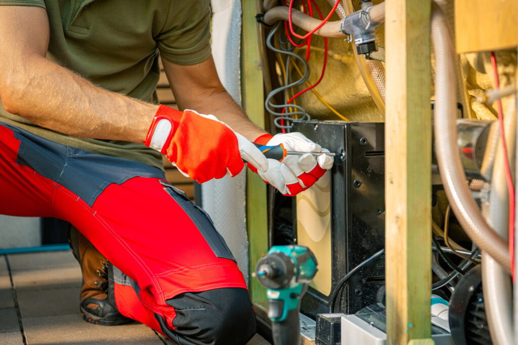 Technician Repairing Outdoor Hot Tub With Tools at an Industrial Facility in the Afternoon
