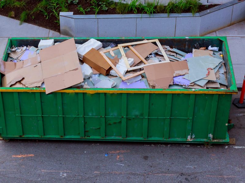Construction waste in an metal container, home house renovation. container for construction waste