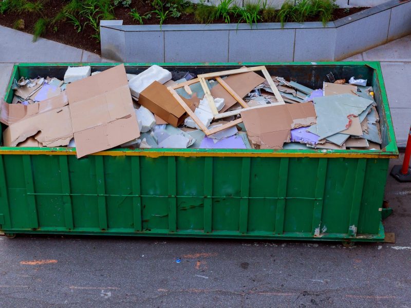 Construction waste in an metal container, home house renovation. container for construction waste