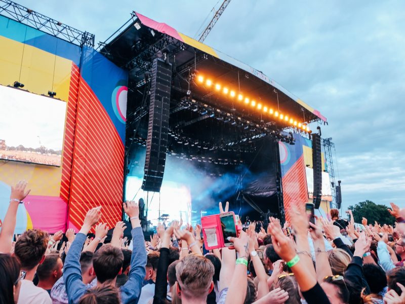 Music festival outdoor stage with crowds dancing