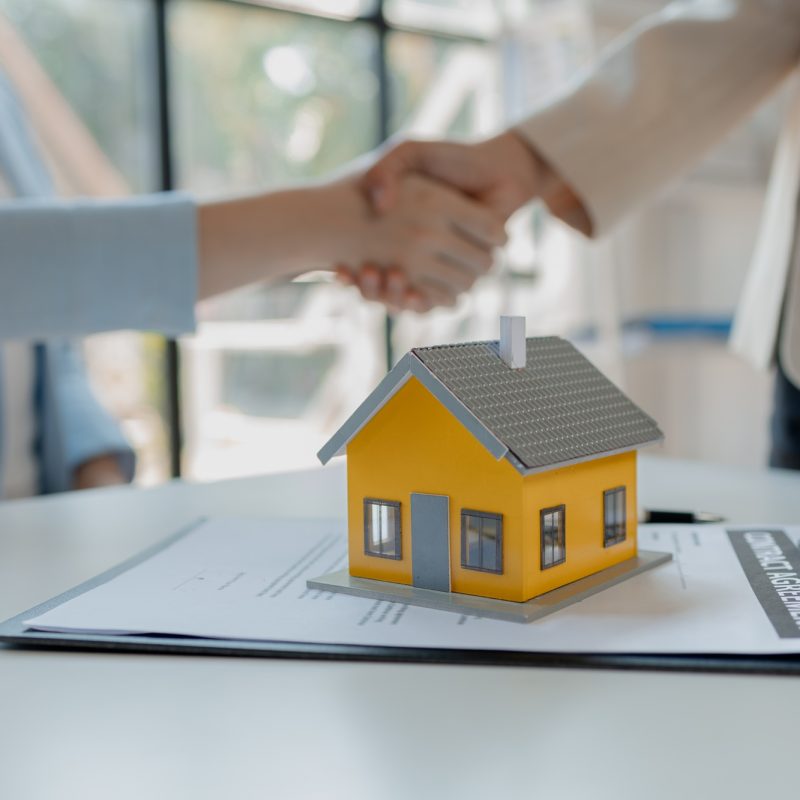 real estate broker manager hand shake to customer after signing contract for buying house, investmen real estate broker manager hand shake to customer after signing contract for buying house, investmen