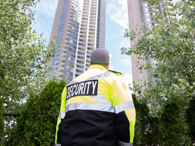 Security guard in uniform patrolling a residential area.