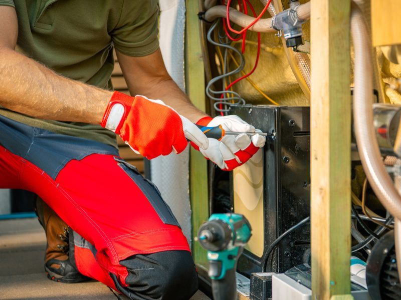 Technician Repairing Outdoor Hot Tub With Tools at an Industrial Facility in the Afternoon