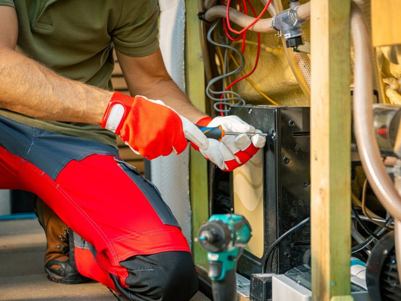 Technician Repairing Outdoor Hot Tub With Tools at an Industrial Facility in the Afternoon